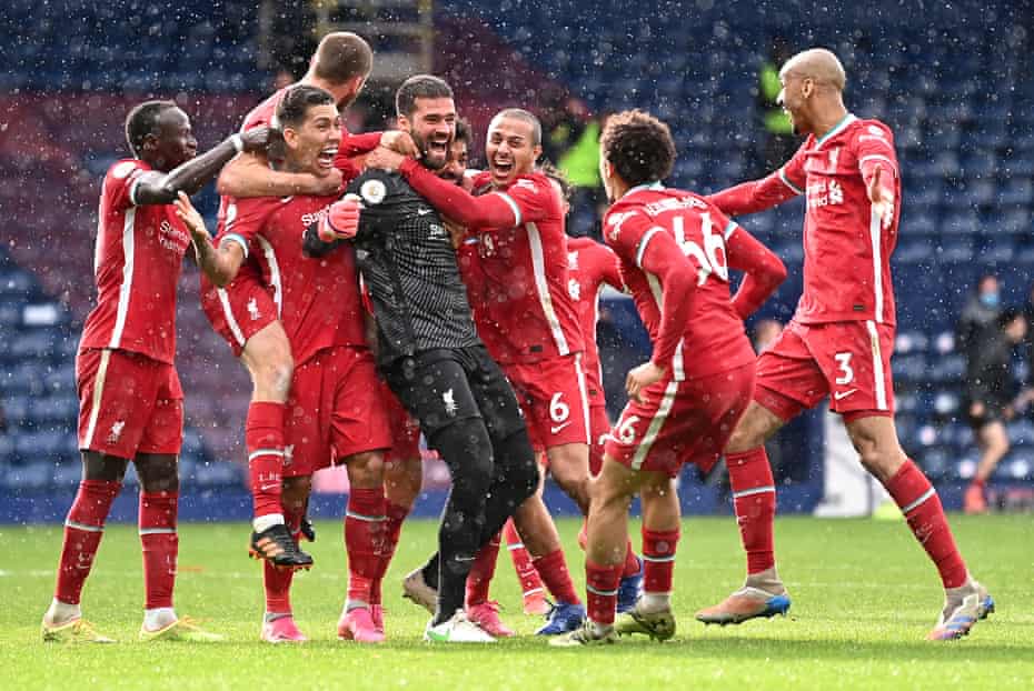 Alisson Becker of Liverpool is congratulated by his team-mates after scoring the winning goal against West Bromwich Albion.