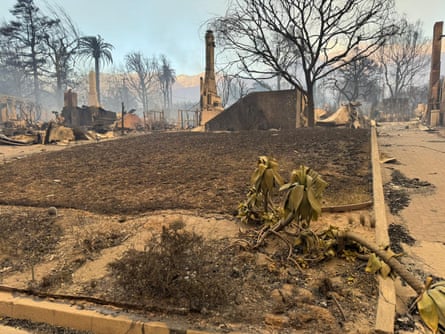 perimeter of a home that has been destroyed, with just a chimney standing in the back