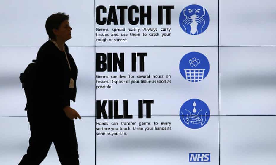 An NHS ‘Catch it, bin it, kill it’ sign on TV screens in London.