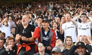 Charlie Cooper next to his father, Paul, at a Fulham game.