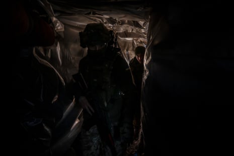 Members of Ukraine’s 63rd Brigade in the underground part of a frontline trench.