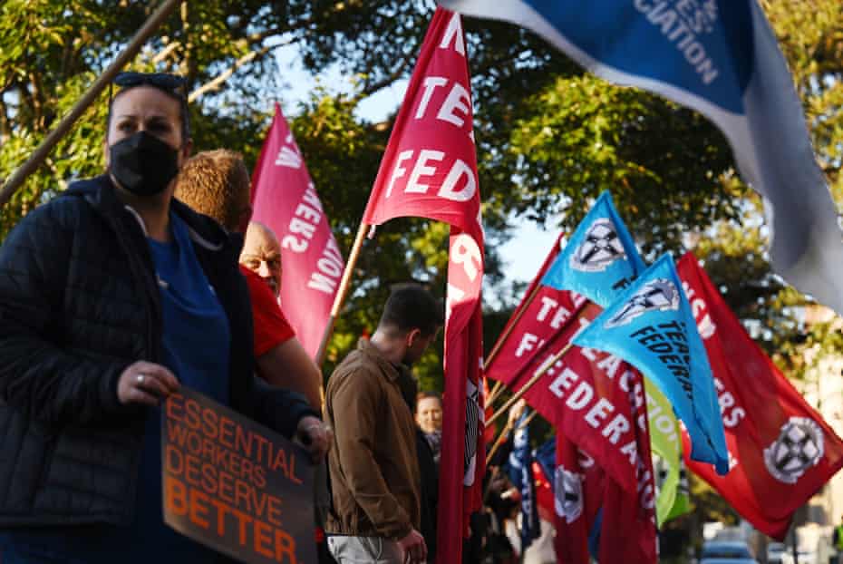 Protesters from unions representing the public and private sector rally outside NSW Parliament House