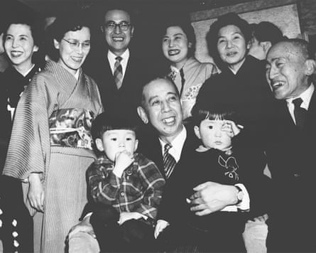 Shinzo Abe, front right, is held by his grandfather Nobusuke Kishi, front center, when Kishi was sworn in as new prime minister at an unknown place in Japan in February 1957. Japan’s longest-serving prime minister, Shinzo Abe was credited with instilling political and economic stability. However, he angered Japan’s neighbors South Korea and China along with many Japanese with his nationalistic rhetoric and calls to revise the country’s pacifist constitution. (Kyodo News via AP)