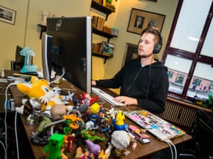 Laidback workplace … Kris Jelbring, systems team lead, sits at his desk filled with video game figurines.