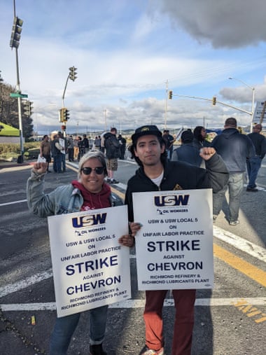 the pair hold signs stating