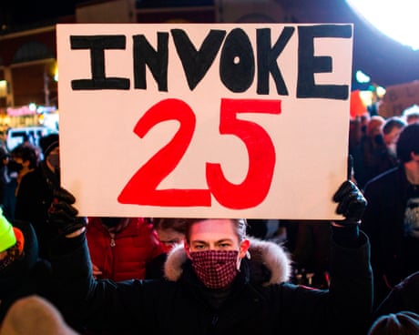 a person holds a sign that reads 'invoke 25'