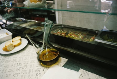 a glass bottle and bread in Gelida