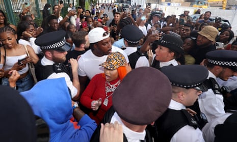 Police escort Nicki Minaj through a throng of fans outside Cafe Koko in Camden, north London