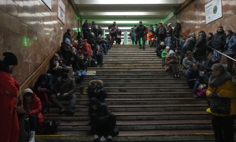 People rest in a subway station, being used as a bomb shelter during a rocket attack in Kyiv, on Friday.