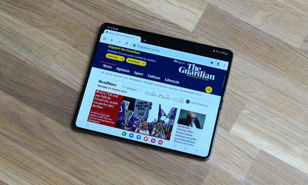 The Guardian site displayed in full-size tablet view on the Z Fold 4 in landscape orientation.