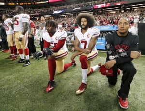 Colin Kaepernick (7) and outside linebacker Eli Harold (58) kneel