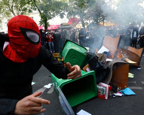 Garbage bins and other objects are set on fire by protesters amid clashes with French police in Paris.
