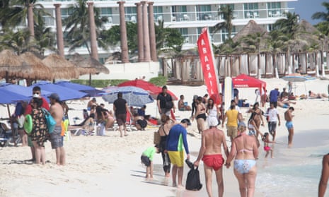 Tourists crowd the beach at Cancún this week.