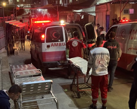 People with stretchers next to ambulances outside the hospital