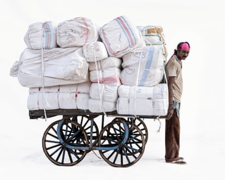 Courier Sanju in Ujjain, Madhya Pradesh, India. He is pulling a cart piled high with packages