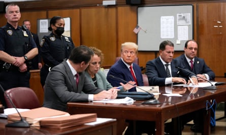 President Donald Trump sits with his attorneys inside the courtroom.
