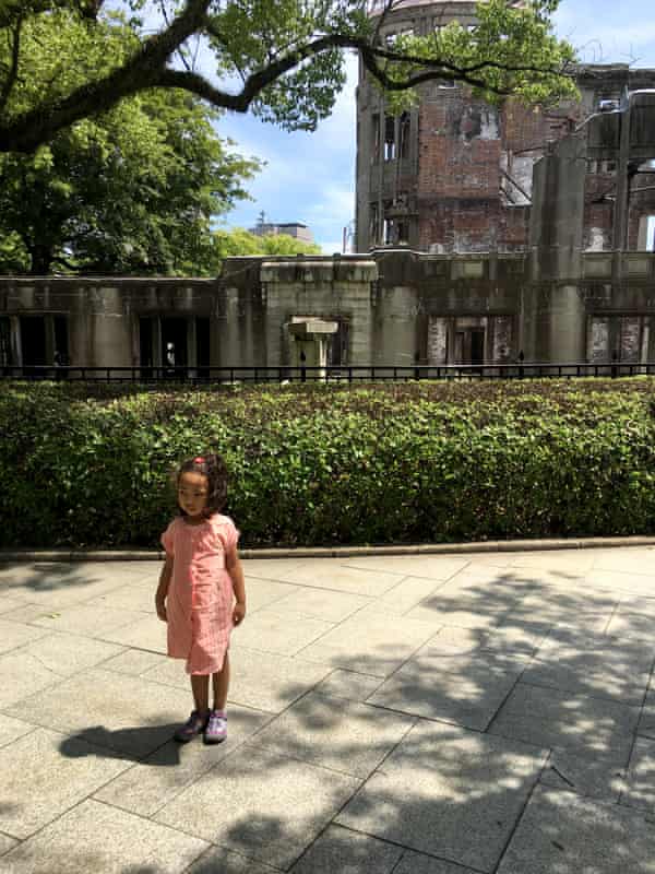 My daughter posing in front of the skeletal remains of the Atomic Bomb Dome during our 2017 trip.