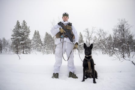 A military officer with a guard dog in a snowy landscape