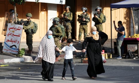 Palestinians and Israeli soldiers during protests against an agreement between Israel and the UAE in the West Bank city of Hebron, September 2020