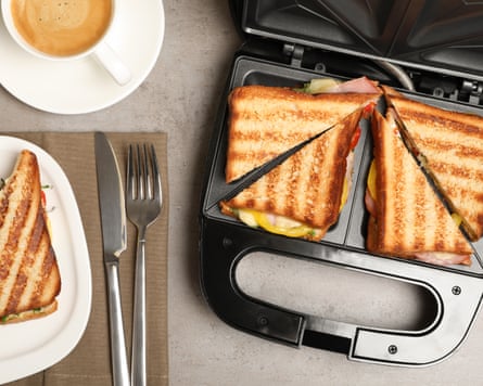 Modern grill maker with tasty sandwiches on light grey table, flat lay