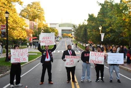 Demonstrators hold signs during a protest against Cornell University’s handling of the 2024 fraternity-house gang rape allegations.