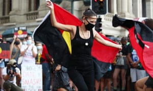 A woman dances during the Invasion Day rally in Brisbane.