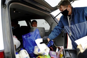 Victor Alvarado Garcia, 9, watches a volunteer place food inside his family’s car outside the Walworth County Food Pantry, as rural hunger rises due to coronavirus pandemic in Elkhorn, Wisconsin, earlier this month.