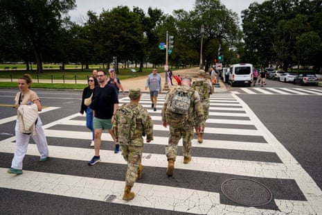 Members of the Mississippi National Guard cross 14th Street on the National Mall after Donald Trump deployed the National Guard and ordered an increased presence of federal law enforcement to assist in crime prevention in Washington DC. (REUTERS/Al Drago)