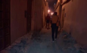 People walk through the rubble during the aftermath in Marrakech in a videograb from Al Oula.