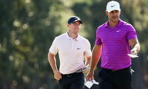 Rory McIlroy of Northern Ireland and Brooks Koepka of the United States walk off the 18th green.