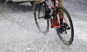 Water splashes from the wheels of the bike of the FDJ rider Alexandre Geniez.