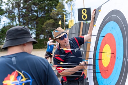A judge checks arrows in a target