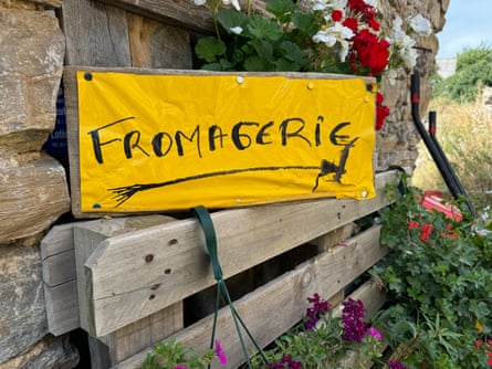 Yellow hand drawn fromagerie sign surrounded by flowers