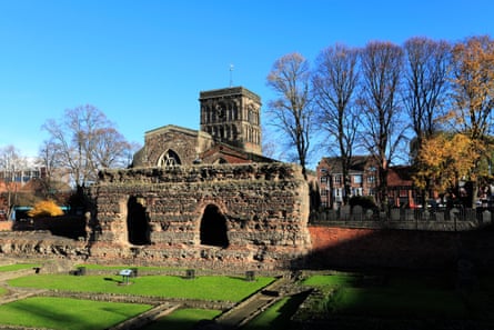 Remains of a Roman building with a cathedral behind in Leicester.