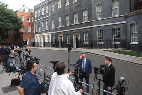 Journalists broadcasting from Downing Street.