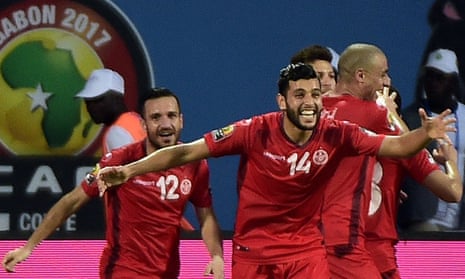 Mohamed Ben Amor, no 14, leads the celebrations amongst the Tunisian players after Algeria’s Mandi scored an own goal.