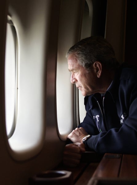George W. Bush looks out the window of Air Force One as he flies over New Orleans, Louisiana, surveying the damage left by hurricane Katrina in 2005.