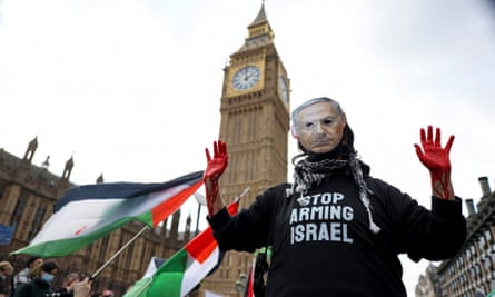 A person wearing a mask of the Israeli prime minister, Benjamin Netanyahu, takes part in a protest in London in solidarity with Palestinians in Gaza.