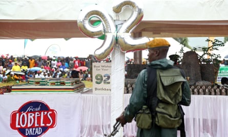 An armed soldier stands guard for Robert Mugabe’s 92nd birthday party.