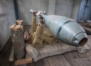 A Ukrainian serviceman exercises with 35 kg weight made from 120mm mortars, in an improvised gym not far of the crisis front line in Vodyane village of Donetsk area, Ukraine, on 16 October