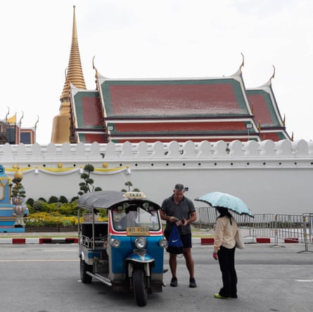 A tourist takes a rickshaw in Bangkok.