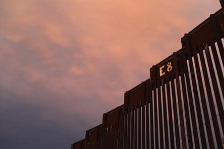 The US-Mexico border fence is seen at sunset on 22 July 2018 in Nogales, Arizona.