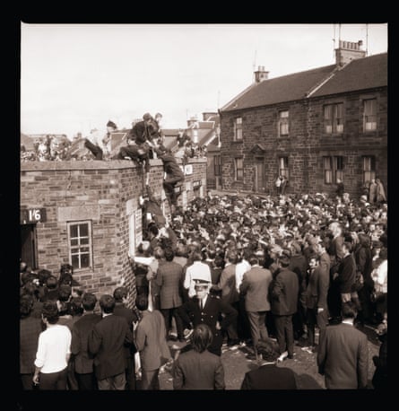 Ayr United fans climb over the turnstiles for their match against Rangers in 1969.