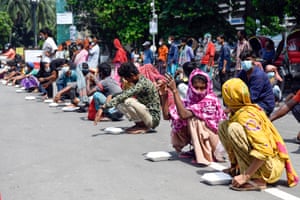 People wait on a street in the Bangladeshi capital Dhaka for free food being distributed amid a hard lockdown to combat Covid-19