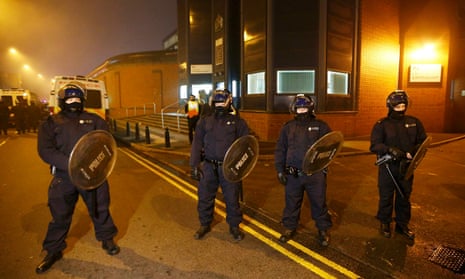 Police officers in riot gear outside Birmingham prison
