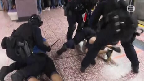 Hong Kong police seen beating protesters during clash at metro station in August – video