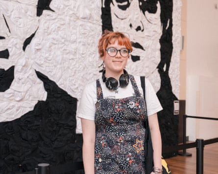 Elinor Maizey in floral dungarees in front of the mural