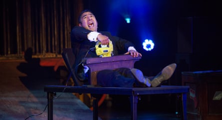 He holds a comedy iron and does comedy ironing