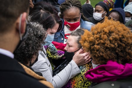 Katie Wright, center right, the mother of Daunte Wright, is embraced by George Floyd’s girlfriend, Courteney Ross, center left, in Minneapolis on 13 April.