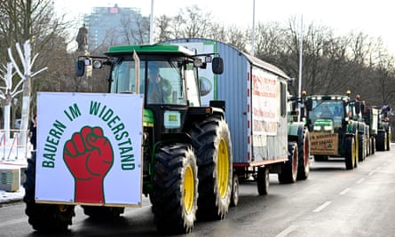 Tractors drive down a street in Berlin